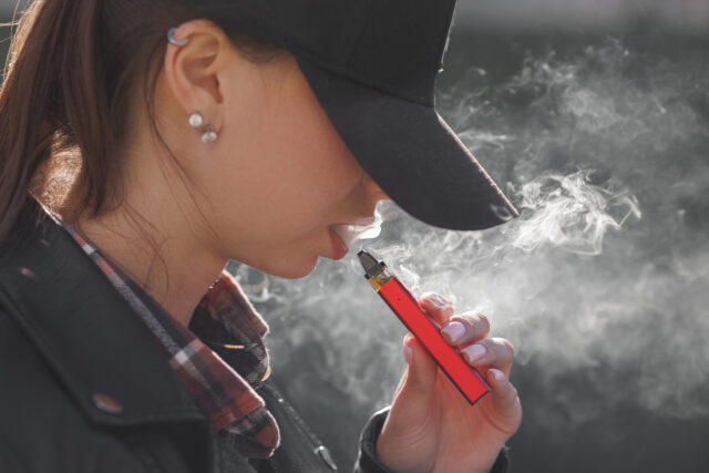 Young Girl Smokes A Vape Close Up On A Dark Backgr 2025 03 20 17 00 10 Utc
