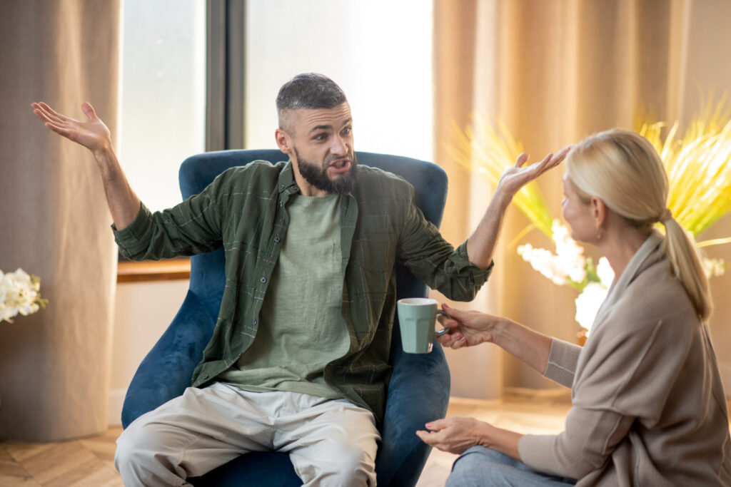 Two Adults In Conversation During Adhd Awareness Month, Highlighting Open Dialogue And Support For Breaking Stigma.